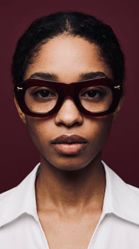 Emi Koussi in burgundy — editorial portrait, Lombia eyewear designed in Johannesburg